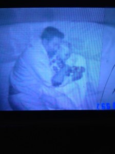 Often the only way to sooth our boy through nocturnal jerks is to hold him tight.  Image from our video monitor.  